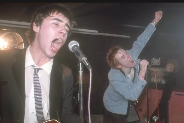 Glen Matlock on stage with Johnny Rotten around 1976