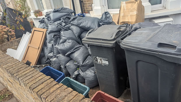 Bin bags in front of house 