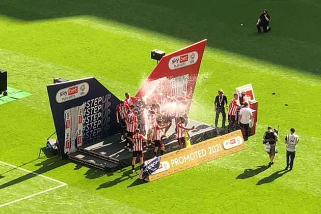 Brentford players celebrate their victory on the pitch