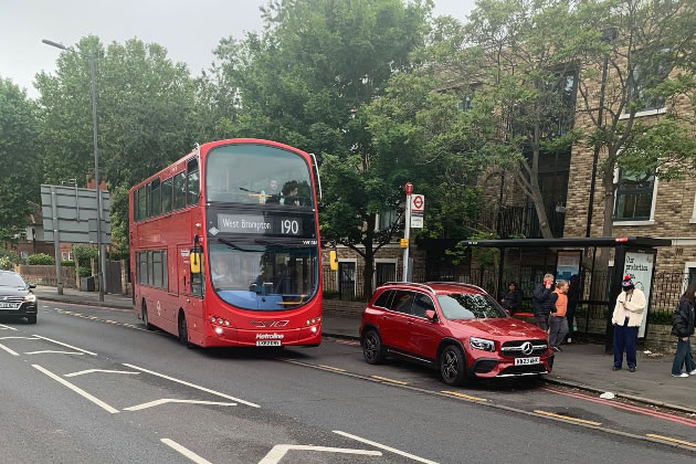 The car at the bus stop near the entrance to the Chiswick Gate estate