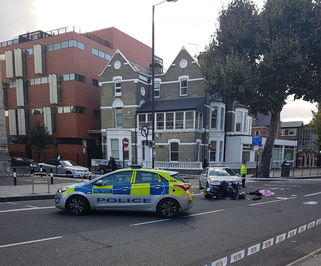 large image of motorcycle lying on the road after collision