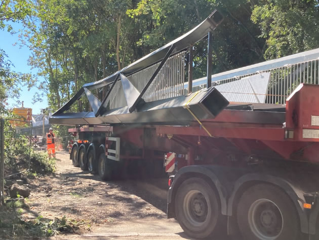 a section of the Dukes Meadows footbridge being delivered by lorry