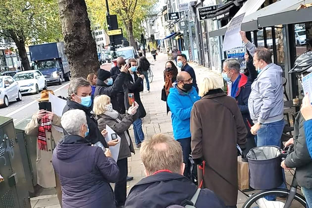 Hanif Khan (in blue coat) surrounded by protestors