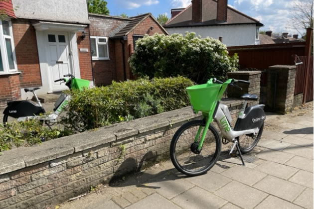 Photo of e-bikes outside and inside a front garden 