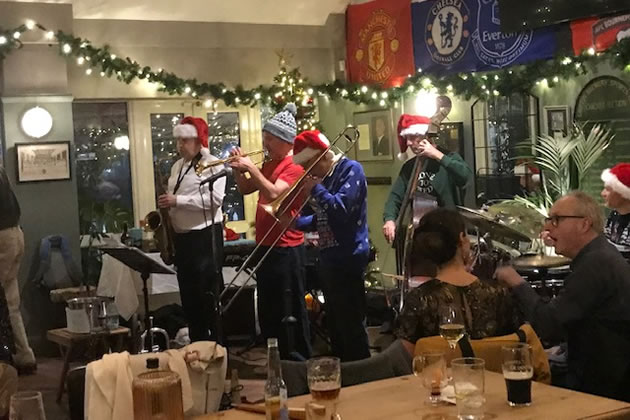 The band performs at the Christmas jazz party