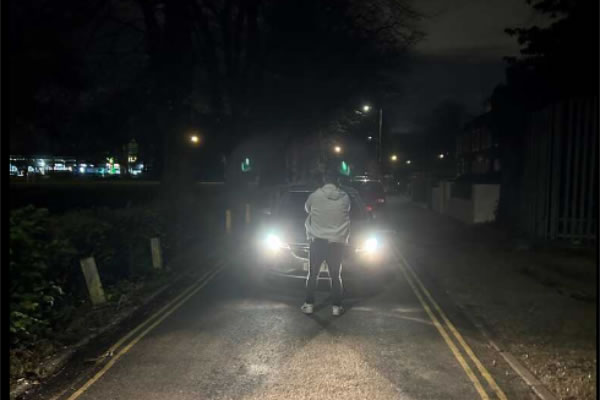 A plain clothes officer stops a car in a local park