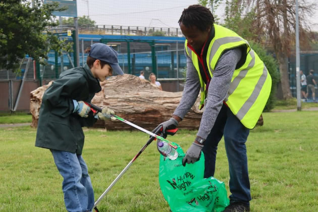 Cllr Ron Mushiso (right) with a young volunteer on Chiswick Back Common 