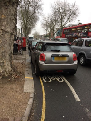 cars parked on sunday blocking bicycle lane