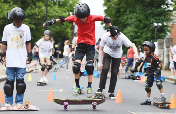 children on skateboards at sports event 