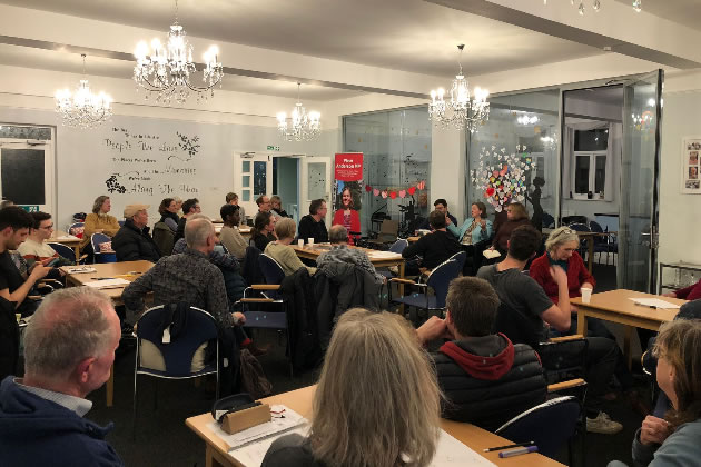 People listening to discussions at the meeting 