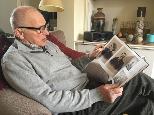 Author Hugh Thompson peruses old photographs 