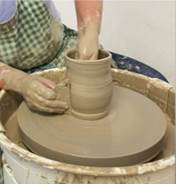 A picture containing person, indoor, potter's wheel  Description automatically generated