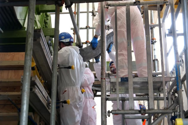 Engineers monitor the pouring of the concrete into a pedestal