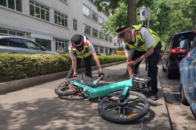 H&F Law Enforcement Team (LET) officers moving a TIER e-bike blocking the pavement