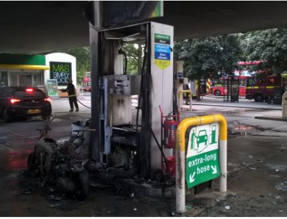 Burnt out moped at Shepherd's Bush petrol station